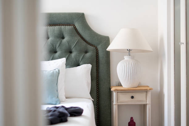 istock Modern Lamp on a night table next to bed, modern pillows in a stylish interior 1224586600