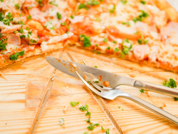 istock knife and fork on a background of pizza. side view 1224592200