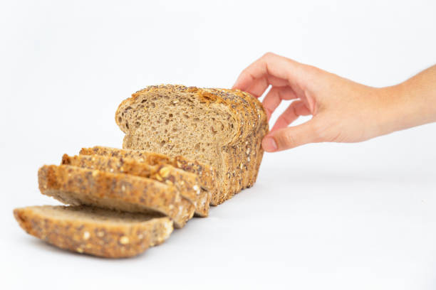 istock Hand taking sliced cereal bread with oatmeal and seeds 1224592225