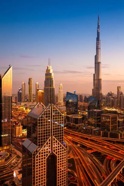 The view of Dubai skyline with Burj Khalifa and Sheikh Zayed road at dusk, UAE.