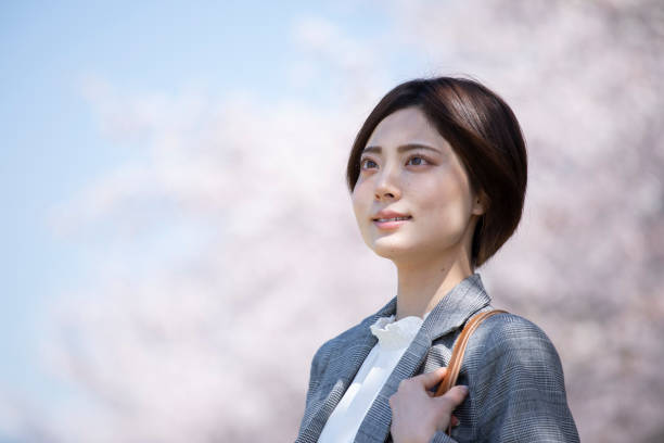 istock Young business woman in a suit with cherry blossoms 1224595421