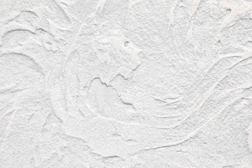 Texture of white concrete wall with glaze finish. Luxury background for design on a building theme, decor theme. Copy space.