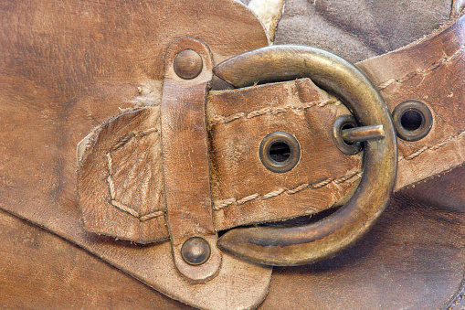 image of a copper clasp on a brown leather boot