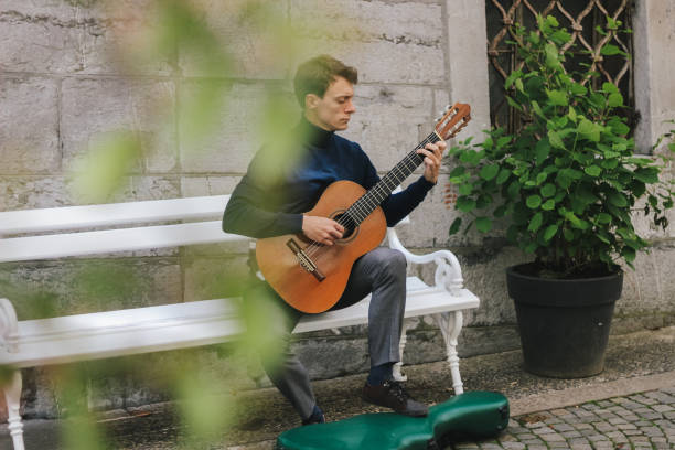 istock Young man playing a guitar outside 1224601745