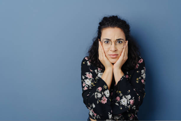 istock Troubled anxious young woman staring at camera 1224602877