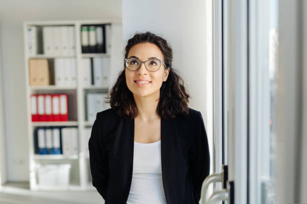 istock Young businesswoman standing deep in thought 1224604598