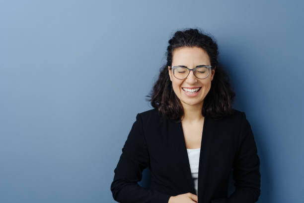 istock Amused young woman giggling to herself 1224605376