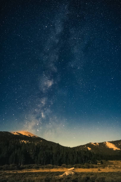 istock Milky way above a moonlit mountain meadow 1224606393