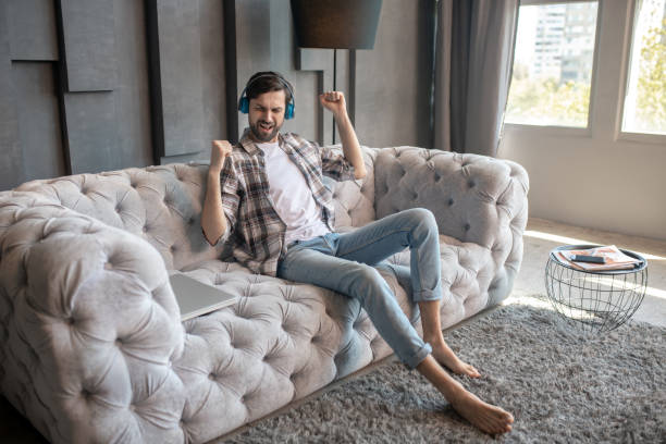 istock Man in headphones with eyes closed singing. 1224608639