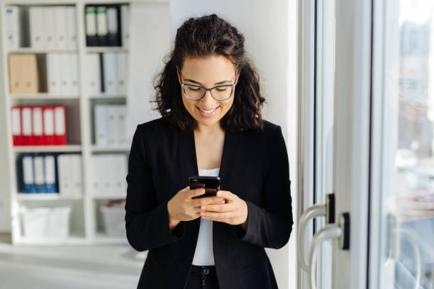 istock Woman reading a text message with a happy grin 1224608785