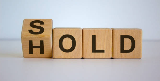 istock Wooden cubes and changes the word 'sold' to 'hold'. Beautiful white background. 1224610073