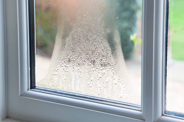 Blown double glazed unit, failed window glazing Close up of blown double glazed unit. Failed window glazing with condensation inside, UK condensation stock pictures, royalty-free photos & images