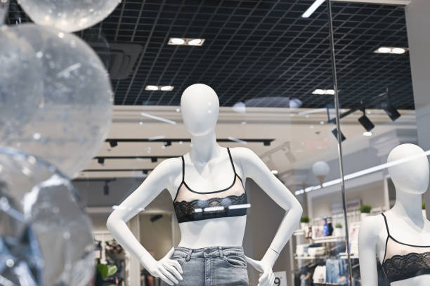 istock White mannequin showing new clothes behind the glass 1224612729