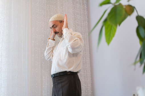 Muslim man praying at home in Ramadan, Turkey