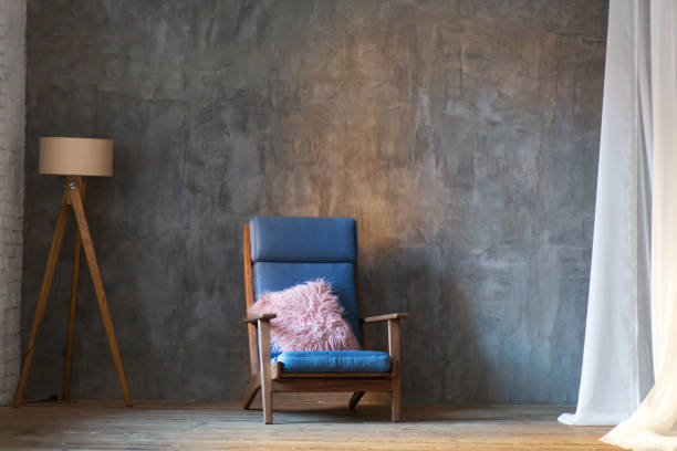 Minimalist interior design. Armchair and lamp on wall background.