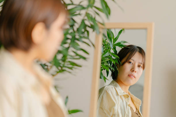 Portrait of young woman reflected on mirror
