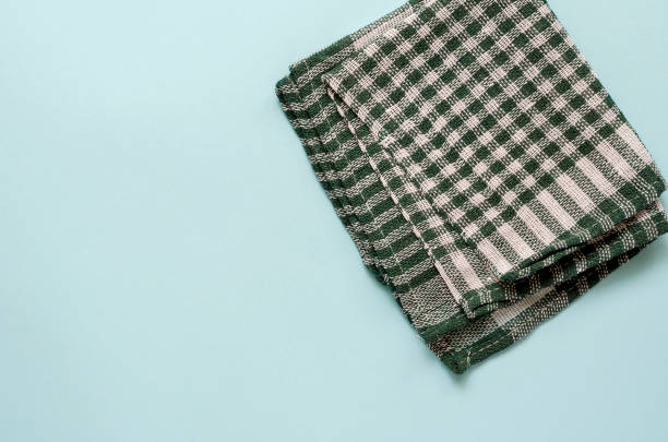 istock Light turquoise background with a green checkered towel 1224615933