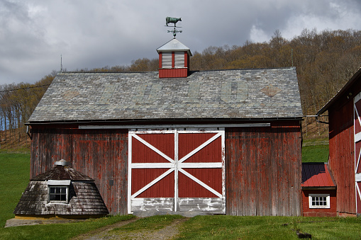 Barn at Spring Hill Farm in Washington, CT. The roof displays the year 1810. Photo taken from public road.