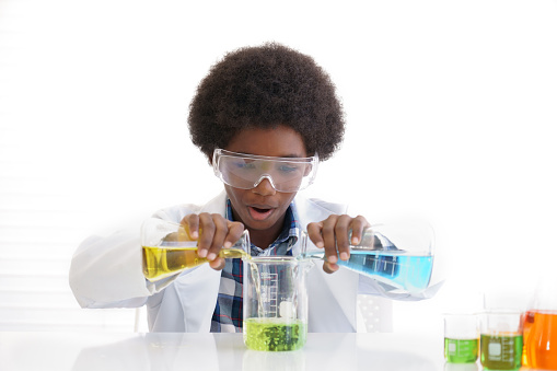 African American boy testing chemistry lab experiment