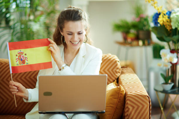 istock housewife with laptop and Spanish flag learn foreign language 1224621276