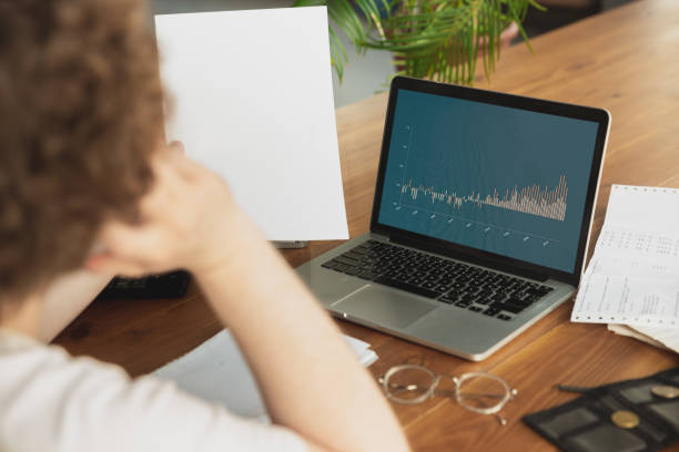 istock Caucasian upset and despair man watching financial and economical graphs going down during coronavirus quarantine, problems 1224621547