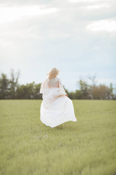 istock girl runs on a green field 1224621819