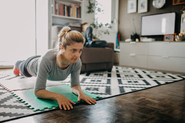 istock Mid adult woman exercising during lockdown 1224622189
