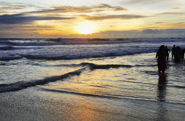 istock People soaking them in Kovalam beach at sunset, Kerala, India 1224623512