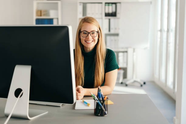 Friendly young secretary or personal assistant stock photo