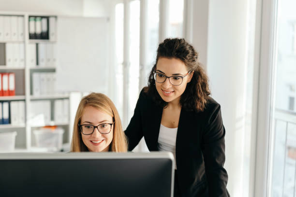 istock Two smart young office co-workers in a meeting 1224625343