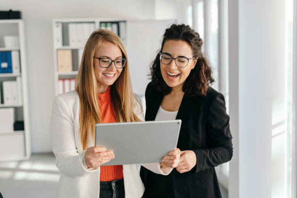 istock Two happy work colleagues laughing together 1224626661