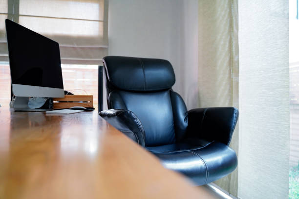 istock Black working chair and mornitor near window at home, working space with blurred table on foreground.Working from home to avoid corona virus.Social distancing and stays at home safe from COVID-19 infection. 1224629270