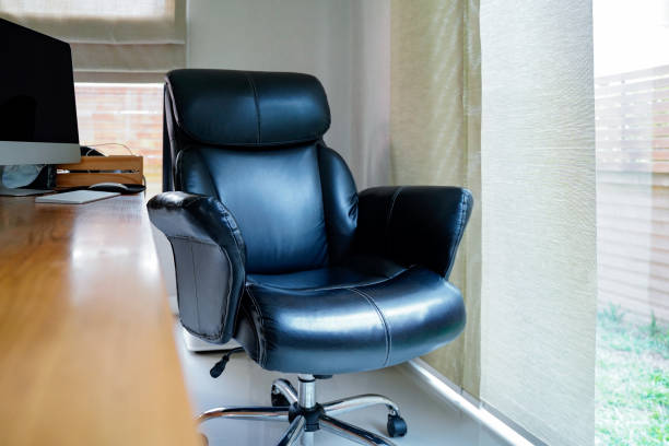 istock Black working chair near window at home working space with blurred table foreground.Working from home to avoid corona virus.Social distancing and stays at home safe from COVID-19 infection. 1224629300