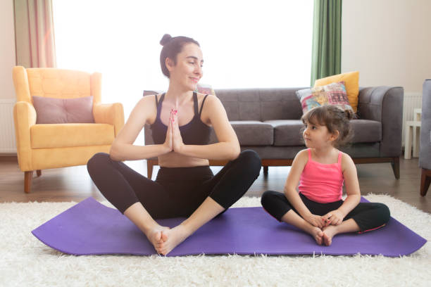 istock Mother and daughter working yoga 1224629480