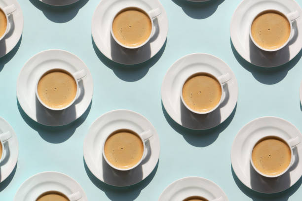 Pattern made of cup of cappuccino on blue background