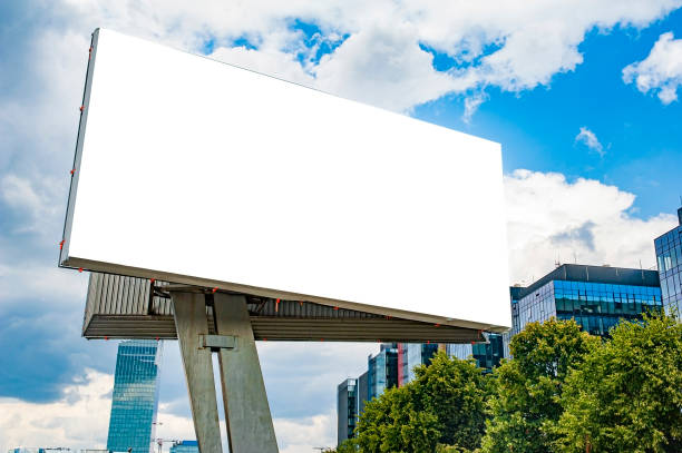 istock Advertising billboard mockup in front of modern office buildings 1224638927