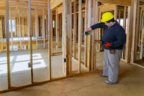istock Inspector man inspects house electrical systems electrician holding tablet PC 1224639022