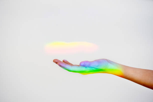 istock Unrecognizable woman hand with a rainbow iconic reflection on the background. 1224639190