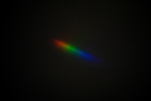 Chromatic pattern of rainbow colors. Horizontal view of conceptual rgb icon isolated on black background.