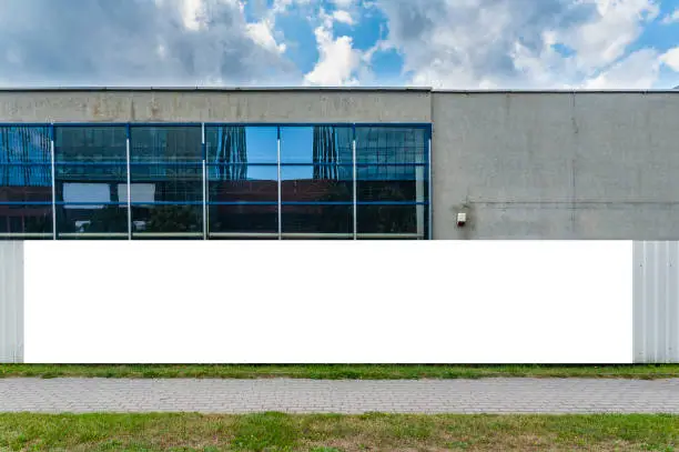 Photo of Advertising banner mockup on the fence of construction site