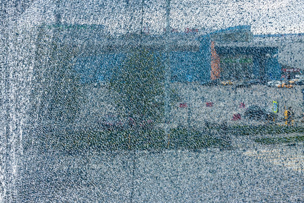 broken glass in an old window in an old tenement house in the city center. act of vandalism.