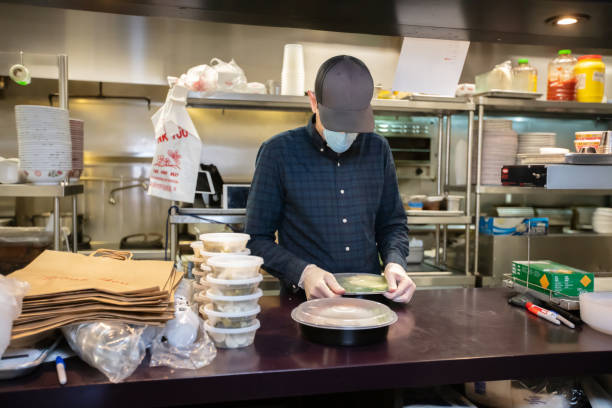 istock Restauranteur Packaging Food for Delivery During Covid-19 Outbreak 1224640607