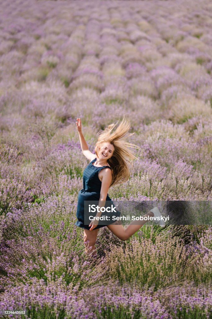 Beautiful Woman Funny Walk On The Lavender Field On Sunset Beautiful Girl  In Dress Stand And Flying Long Hair On Purple Lavender Field Soft Focus  Enjoy The Floral Glade Summer Nature Hairstyle