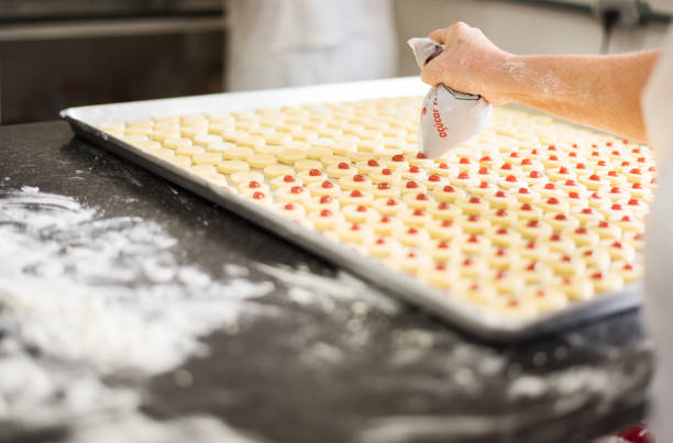 istock Carefully placing the topping on the cookies 1224643503