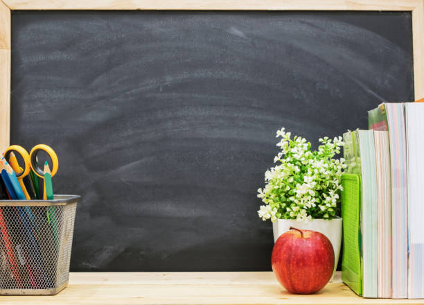 istock Red apple, pencil, books with black board as background, back to school concept. 1224644050
