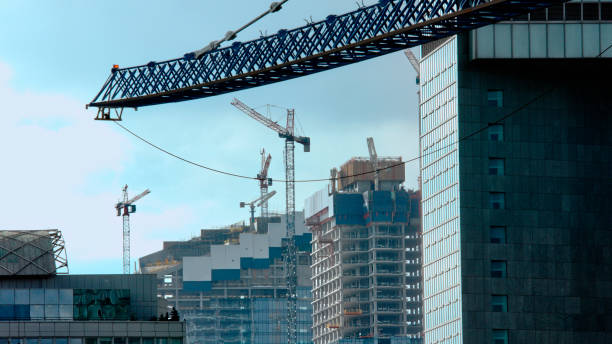 istock Construction cranes next to skyscrapers. Big city panorama 1224646433