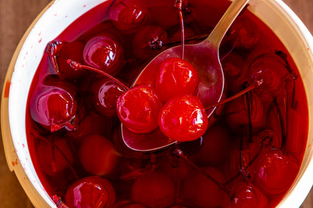Delicious cherries in bowl on wooden background