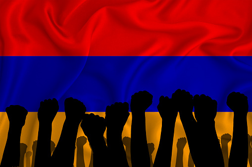 Silhouette of raised arms and clenched fists on the background of the flag of armenia. The concept of power,  conflict. With place for your text. 3D rendering