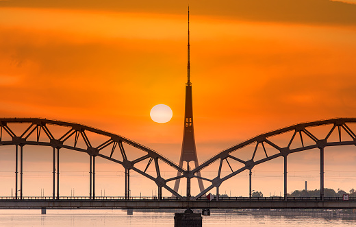 Riga, amazing sunset over Daugava river, bridge and TV tower, Latvia