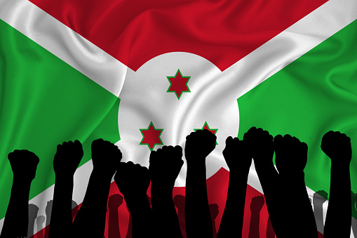 Silhouette of raised arms and clenched fists on the background of the flag of Burundi. The concept of power,  conflict. With place for your text. 3D rendering